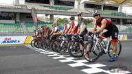 At Sepang the riders challenge each othher on two wheels... on bicycles